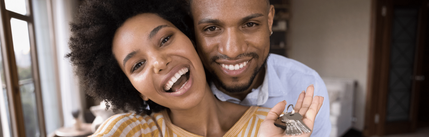 Joyful Young African American Couple Showing Keys. Joint Tenancy With Right of Survivorship Concept.