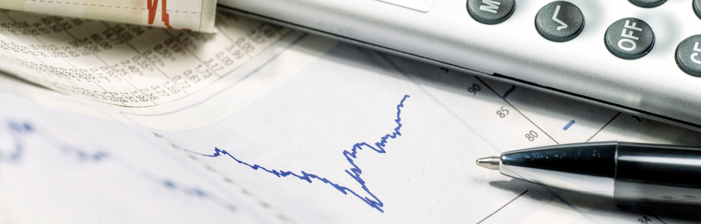 Graphics of stock exchange prices with calculator and pen. Volatility Concept.